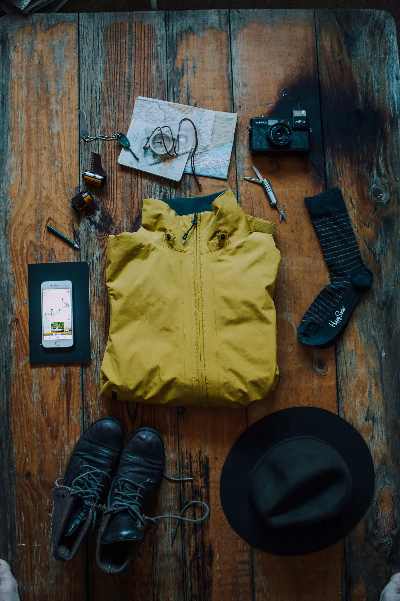 gear-flatlay-yellow-jacket-wood-rustic